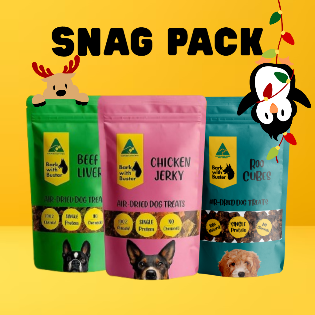 Three air-dried dog treat packages with 'Bark with Buster' branding on a yellow background. Ready for Christmas