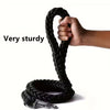 Hand holding a black braided dog rope with a metal clip on a white background, labeled 'Very sturdy'.