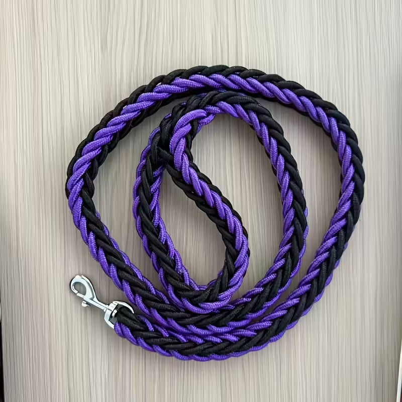 Black and purple braided leash on a wooden surface