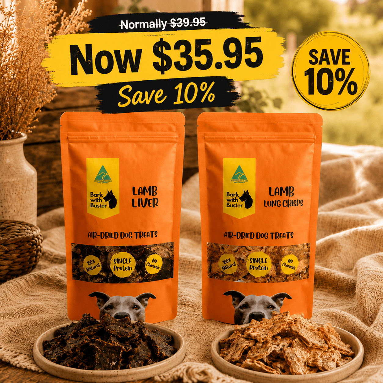 Bark with Buster Lamb Discovery Box with lamb liver and lamb lung crisps now $35.95, save 10%. Two orange stand-up pouches of Book with Butter Lamb Liver and Lamb Lung Chops single-ingredient dog treats are displayed on a burlap surface with bowls of the treats in front. The image includes promotional text overlays showing a price drop and a 10% savings badge.